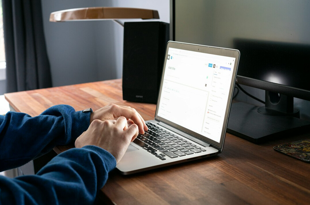 web developer at desk with laptop