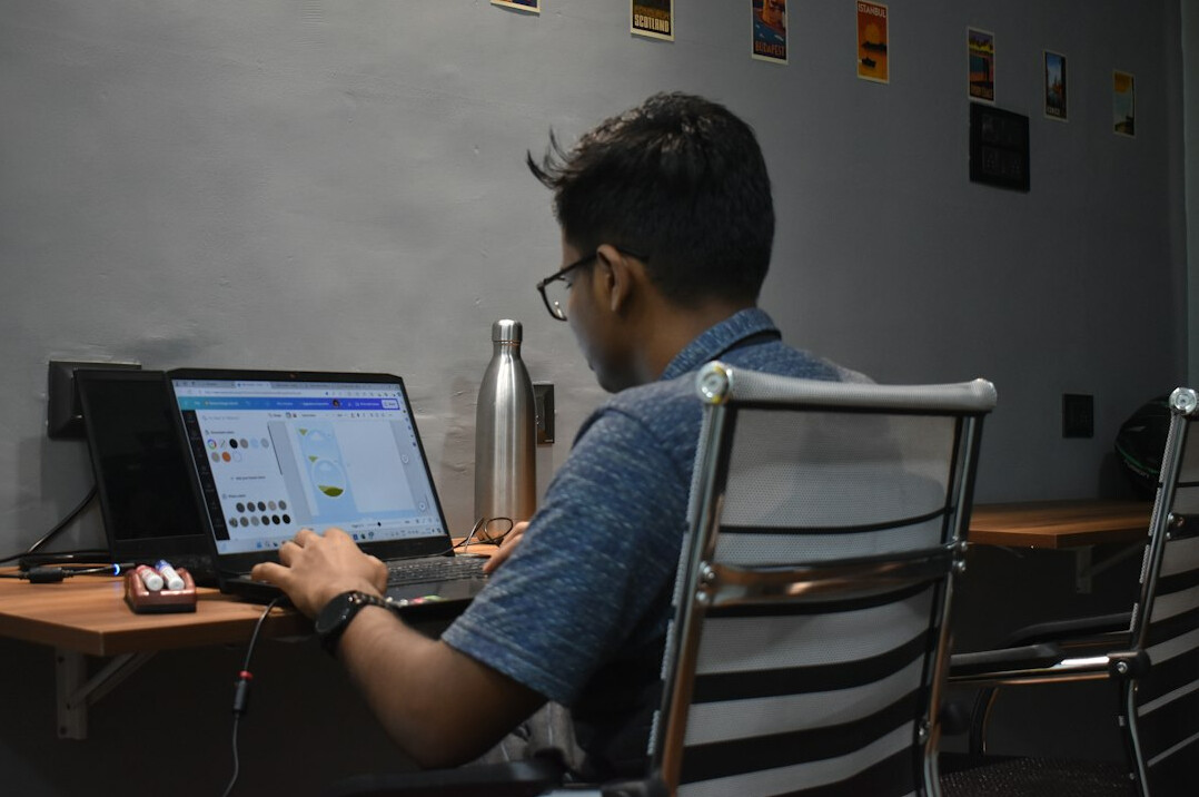 young man coding on laptop
