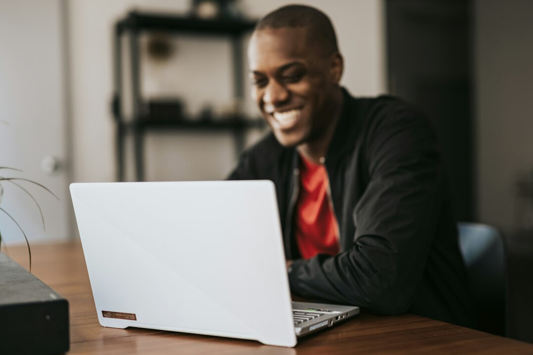 person coding on laptop happily