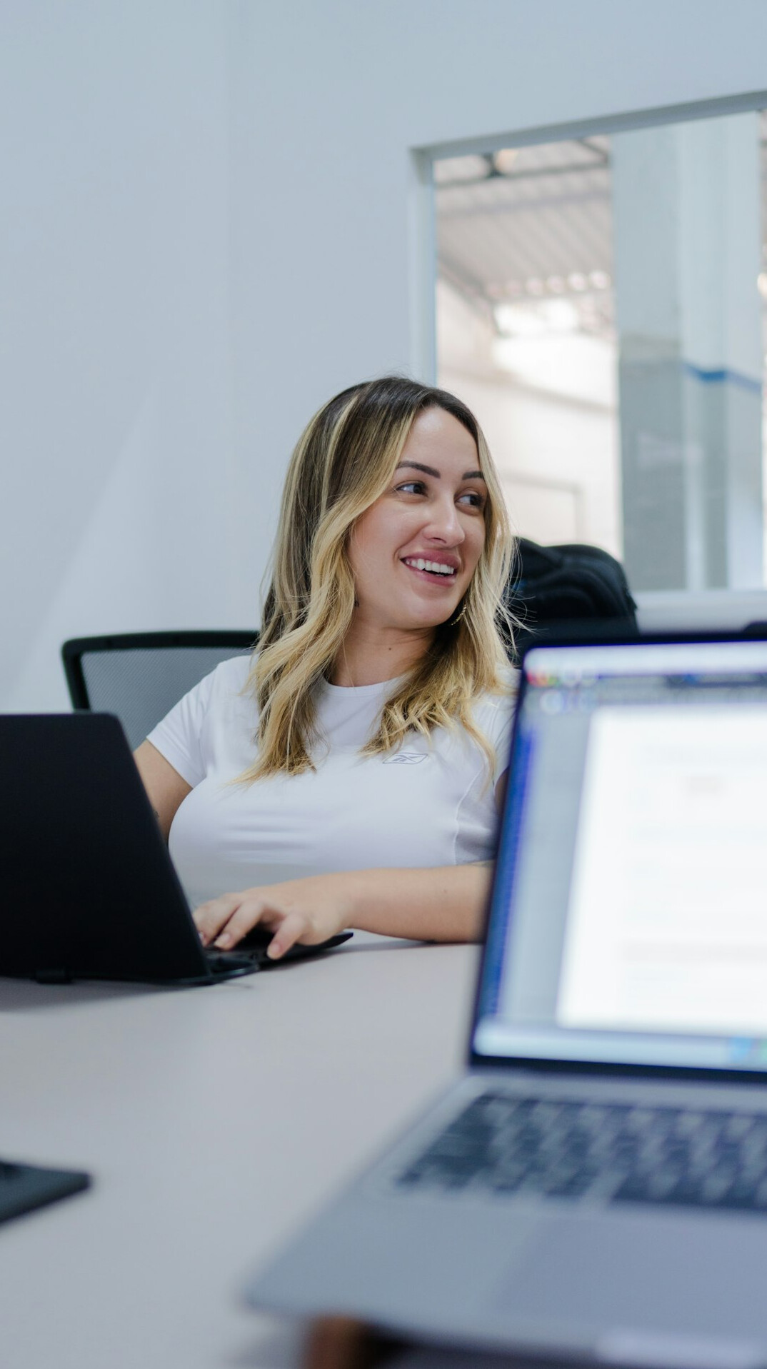 woman smiling while coding