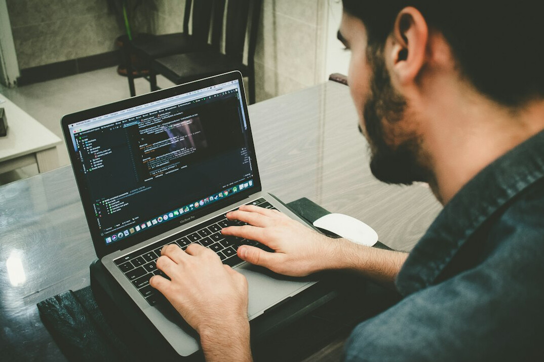 web developer coding on laptop