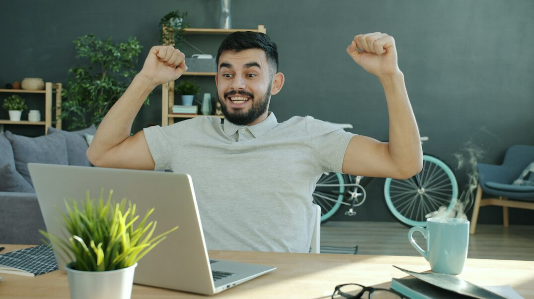 person coding on laptop happily